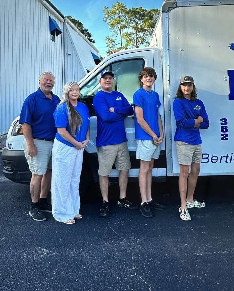 The Bertie family in front of the Bertie Heating & Air building in Gainesville