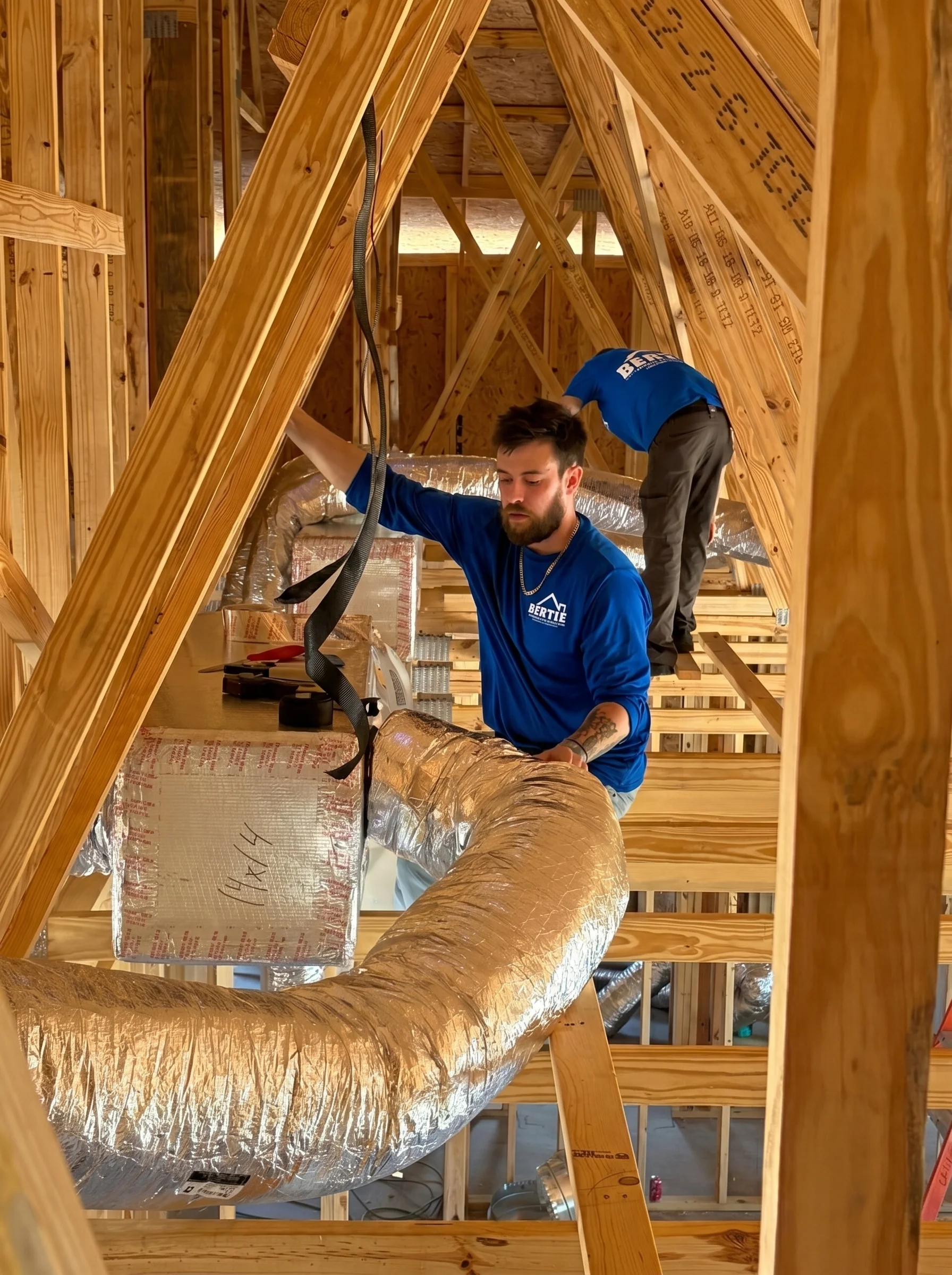 Bertie Air technicians installing ductwork in a new-construction home
